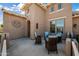 Inviting outdoor patio with stylish wicker furniture, perfect for relaxing and enjoying the neighborhood at 20453 W Daniel Pl, Buckeye, AZ 85396
