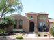 Charming two-story home featuring a tile roof, arched windows, and landscaped yard at 20453 W Daniel Pl, Buckeye, AZ 85396