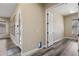 Hallway with wood floors, neutral paint and access to the backyard at 20453 W Daniel Pl, Buckeye, AZ 85396