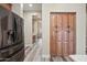 Hallway featuring a stainless steel refrigerator and wooden pantry with plank flooring at 20453 W Daniel Pl, Buckeye, AZ 85396