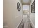 Bright hallway with gray wood floors and decorative wall art at 20453 W Daniel Pl, Buckeye, AZ 85396