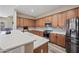 Modern kitchen with stainless steel appliances, granite counters, and lots of cabinets at 20453 W Daniel Pl, Buckeye, AZ 85396