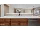 Kitchen quartz counter and sink with view of adjacent room and plank flooring at 20453 W Daniel Pl, Buckeye, AZ 85396