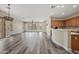 Spacious living room with lots of natural light, wood floors, and an open concept layout to kitchen at 20453 W Daniel Pl, Buckeye, AZ 85396