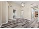 Spacious living room features modern lighting, vaulted ceiling and stylish gray wood flooring at 20453 W Daniel Pl, Buckeye, AZ 85396