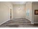 Spacious living room with tall ceilings, wood floors, plantation shutters, and modern lighting at 20453 W Daniel Pl, Buckeye, AZ 85396