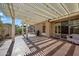 Spacious covered patio area, perfect for outdoor entertaining and relaxation, with a barbecue grill at 20453 W Daniel Pl, Buckeye, AZ 85396