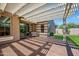 The covered patio features a bench and views of the grassy backyard at 20453 W Daniel Pl, Buckeye, AZ 85396