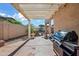 Covered patio with ample space, offering shade and views of the landscaped backyard with privacy wall at 20453 W Daniel Pl, Buckeye, AZ 85396
