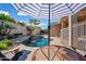 A beautiful lagoon-style pool includes a fountain and lush, mature landscaping at 20453 W Daniel Pl, Buckeye, AZ 85396