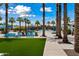 Community pool features a variety of seating and lounge options, tropical landscaping, and clear blue water at 20453 W Daniel Pl, Buckeye, AZ 85396