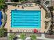Aerial view of a community lap pool with clearly marked lanes and surrounding lounge chairs at 20453 W Daniel Pl, Buckeye, AZ 85396