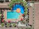 Aerial view of community pool and splashpad surrounded by palm trees and lounge chairs at 20453 W Daniel Pl, Buckeye, AZ 85396