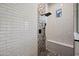 Modern shower with black fixtures, white subway tile, and mosaic accent wall at 20453 W Daniel Pl, Buckeye, AZ 85396