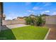 This backyard features synthetic grass, pavers and a block fence for privacy at 21582 W Cocopah St, Buckeye, AZ 85326