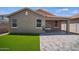 Exterior view of backyard with artificial grass, a patio and a covered patio at 21582 W Cocopah St, Buckeye, AZ 85326