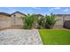 Well maintained backyard shows synthetic grass, gravel, pavers and green landscaping at 21582 W Cocopah St, Buckeye, AZ 85326