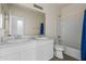 Bright bathroom featuring double sinks, a shower-tub combo, and white cabinets at 21582 W Cocopah St, Buckeye, AZ 85326