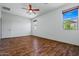 Bedroom with wood floors, windows, closet, and ceiling fan, offering a well-lit and comfortable retreat at 21582 W Cocopah St, Buckeye, AZ 85326