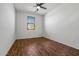 Comfortable bedroom with wood look floors, a ceiling fan and a window letting in natural light at 21582 W Cocopah St, Buckeye, AZ 85326