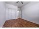 Simple bedroom with wood look floors and a closet with white doors at 21582 W Cocopah St, Buckeye, AZ 85326