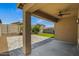 Covered patio with a ceiling fan with pavers leading to artificial grass at 21582 W Cocopah St, Buckeye, AZ 85326