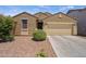 Inviting single-story home featuring low-maintenance desert landscaping and a neutral-colored facade at 21582 W Cocopah St, Buckeye, AZ 85326