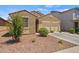 Well-maintained home displaying desert landscaping and a practical two-car garage, ideal for easy living at 21582 W Cocopah St, Buckeye, AZ 85326