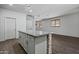Open-concept kitchen featuring a spacious island, bright lighting, and seamless flow to other areas at 21582 W Cocopah St, Buckeye, AZ 85326