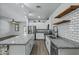 Modern kitchen featuring a large island, stainless steel appliances, and stylish white cabinetry at 21582 W Cocopah St, Buckeye, AZ 85326