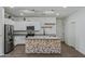 Bright, modern kitchen with stainless steel appliances, a unique island, and sleek subway tile backsplash at 21582 W Cocopah St, Buckeye, AZ 85326