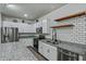 Modern kitchen boasting stainless steel appliances, white cabinets, and granite countertops at 21582 W Cocopah St, Buckeye, AZ 85326