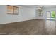 Open living room with tile flooring, ceiling fan, and bright natural lighting at 21582 W Cocopah St, Buckeye, AZ 85326