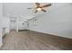 Spacious living room with stylish wood flooring and ceiling fan, offering comfort and modern appeal at 21582 W Cocopah St, Buckeye, AZ 85326