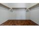 Spacious walk-in closet with wooden rods, offering ample storage and organization options at 21582 W Cocopah St, Buckeye, AZ 85326