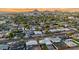 Expansive aerial view of the neighborhood showcasing the property's location amidst tree-lined streets and mountain views at 2225 E Monterosa St, Phoenix, AZ 85016