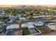 Wide aerial showcasing the neighborhood and the home's landscaping against a backdrop of majestic mountains at sunset at 2225 E Monterosa St, Phoenix, AZ 85016