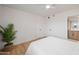 Bright bedroom with a plush white bed, wood floors, and a neutral color palette for a serene retreat at 2225 E Monterosa St, Phoenix, AZ 85016