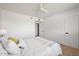 Cozy bedroom with white walls, wood floors, and a soft ceiling fan for comfort at 2225 E Monterosa St, Phoenix, AZ 85016