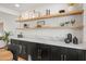 A modern dining room features floating shelves, sleek cabinetry, and a marble countertop for a stylish, functional space at 2225 E Monterosa St, Phoenix, AZ 85016
