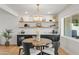 Stylish dining room with modern lighting, open shelving, and a comfortable seating arrangement at 2225 E Monterosa St, Phoenix, AZ 85016