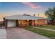 Quaint brick home with decorative ironwork, a lush lawn, and an inviting, covered carport at 2225 E Monterosa St, Phoenix, AZ 85016