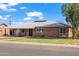 Traditional red brick home with a well-kept lawn and lovely curb appeal at 2225 E Monterosa St, Phoenix, AZ 85016