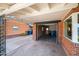 Attached garage featuring modern steel carport, surrounded by manicured landscaping and accented with brick exterior at 2225 E Monterosa St, Phoenix, AZ 85016