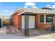 Brick home featuring a quaint attached garage with a modern steel carport, surrounded by landscaped accents at 2225 E Monterosa St, Phoenix, AZ 85016