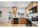 Updated kitchen featuring wood cabinetry, modern appliances, a marble countertop, and backyard views at 2225 E Monterosa St, Phoenix, AZ 85016