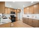 Updated kitchen featuring wood cabinetry, modern appliances, and a marble countertop for a classic look at 2225 E Monterosa St, Phoenix, AZ 85016