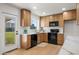Updated kitchen featuring wood cabinetry, modern appliances, a marble countertop, and backyard views at 2225 E Monterosa St, Phoenix, AZ 85016