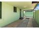 This covered back porch leads to a green garage, providing a private outdoor area at 2230 N 12Th St # Rear, Phoenix, AZ 85006