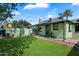 Spacious backyard with a green lawn, a brick patio, and shade trees at 2230 N 12Th St # Rear, Phoenix, AZ 85006